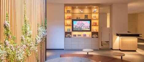 A modern interior with a wooden wall, a round table, and a seating area.
