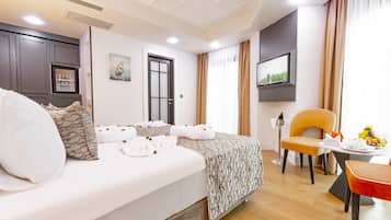 Relax in a spacious room with a large bed, flat-screen TV, and wardrobe.