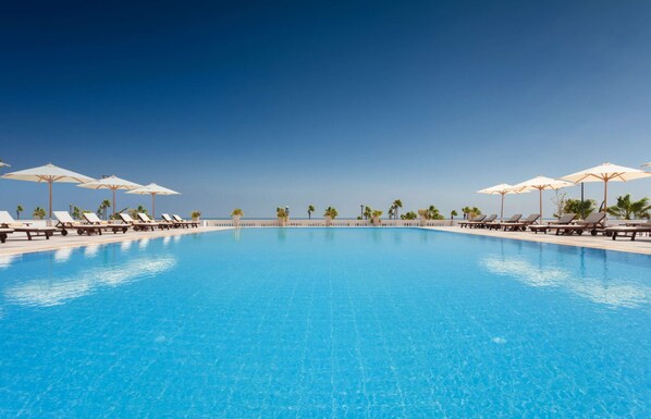 Outdoor pool, pool umbrellas, sun loungers
