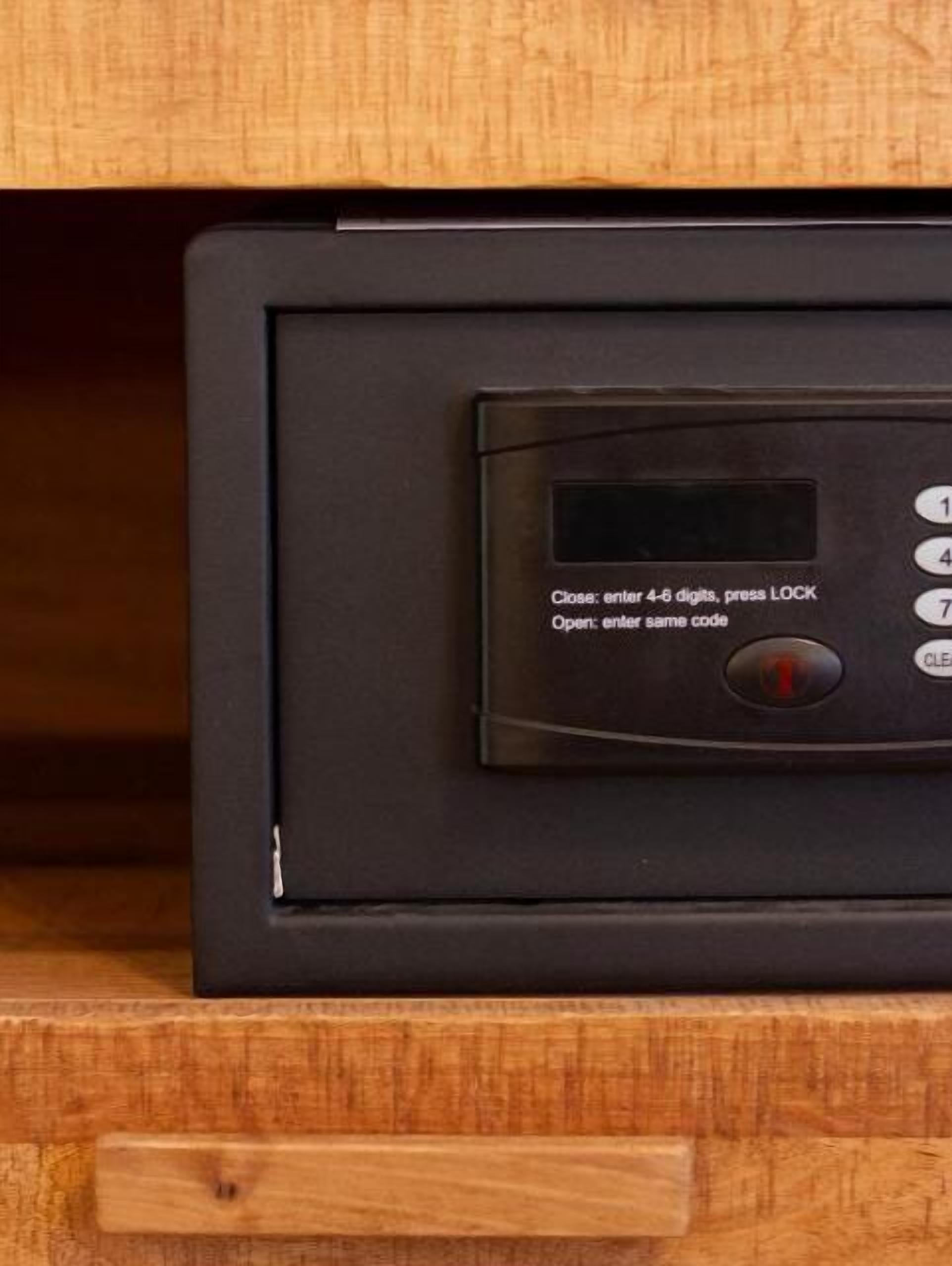 A black electronic device with a keypad and a screen, likely a security system or control panel.