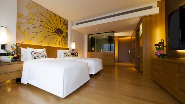 A modern hotel room with two beds, wooden flooring, a large abstract painting on the wall, and a wooden wardrobe. - Wingtech Hotel (Huangshi)