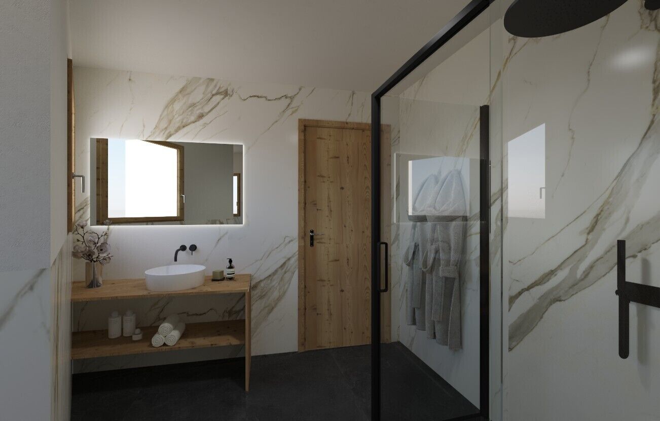 A modern bathroom with a marble wall, a wooden door, a glass shower enclosure, and a sink with a mirror.