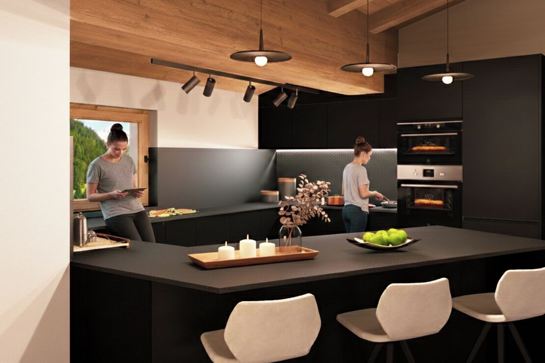 A modern kitchen with a central island, pendant lighting, and built-in appliances.