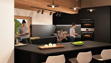 A modern kitchen with a central island, pendant lighting, and built-in appliances.