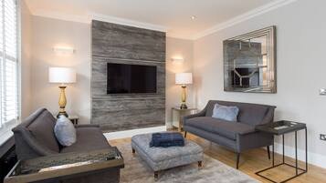 Apartment, 2 Bedrooms | Living area | 55-inch flat-screen TV with digital channels, Smart TV, iPod dock