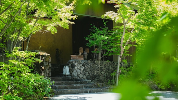 A stone staircase leading to a building with a sign reading "Ancient Hotel." - Ancient Hotel asama karuizawa (Karuizawa)