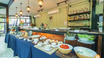 A buffet setup with various food items and beverages.