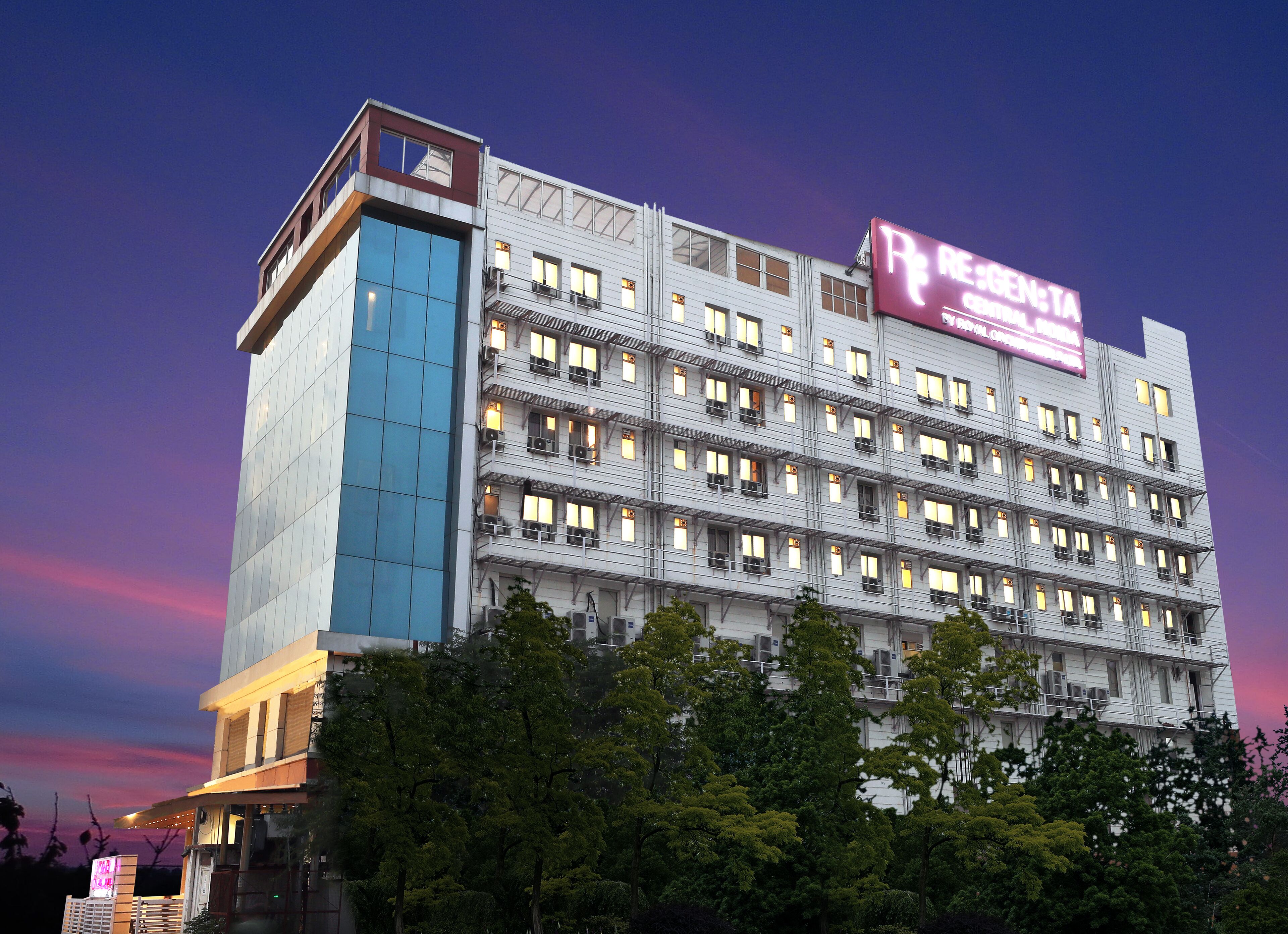 A multi-story hotel with a modern design, featuring a prominent signage for 'RESORT' and 'RESORT HOTEL'.