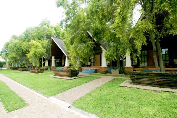 A row of modern buildings with a brick pathway leading to the entrance.