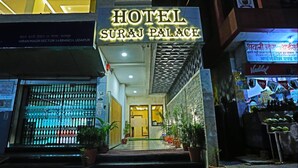 The entrance to Hotel Suraj Palace, featuring a prominent sign, a tiled entrance, and potted plants. - Hotel Suraj Palace (Udaipur)