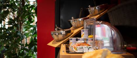 Una mesa de buffet con diferentes alimentos y utensilios.