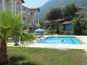 Seasonal outdoor pool, open 9:00 AM to 8:00 PM, pool umbrellas