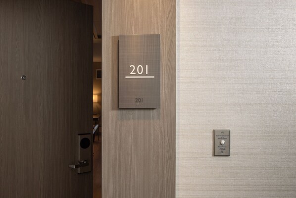 A door with a number plate labeled "201" and a wall-mounted intercom. - AC Hotel Miami Wynwood (Miami)