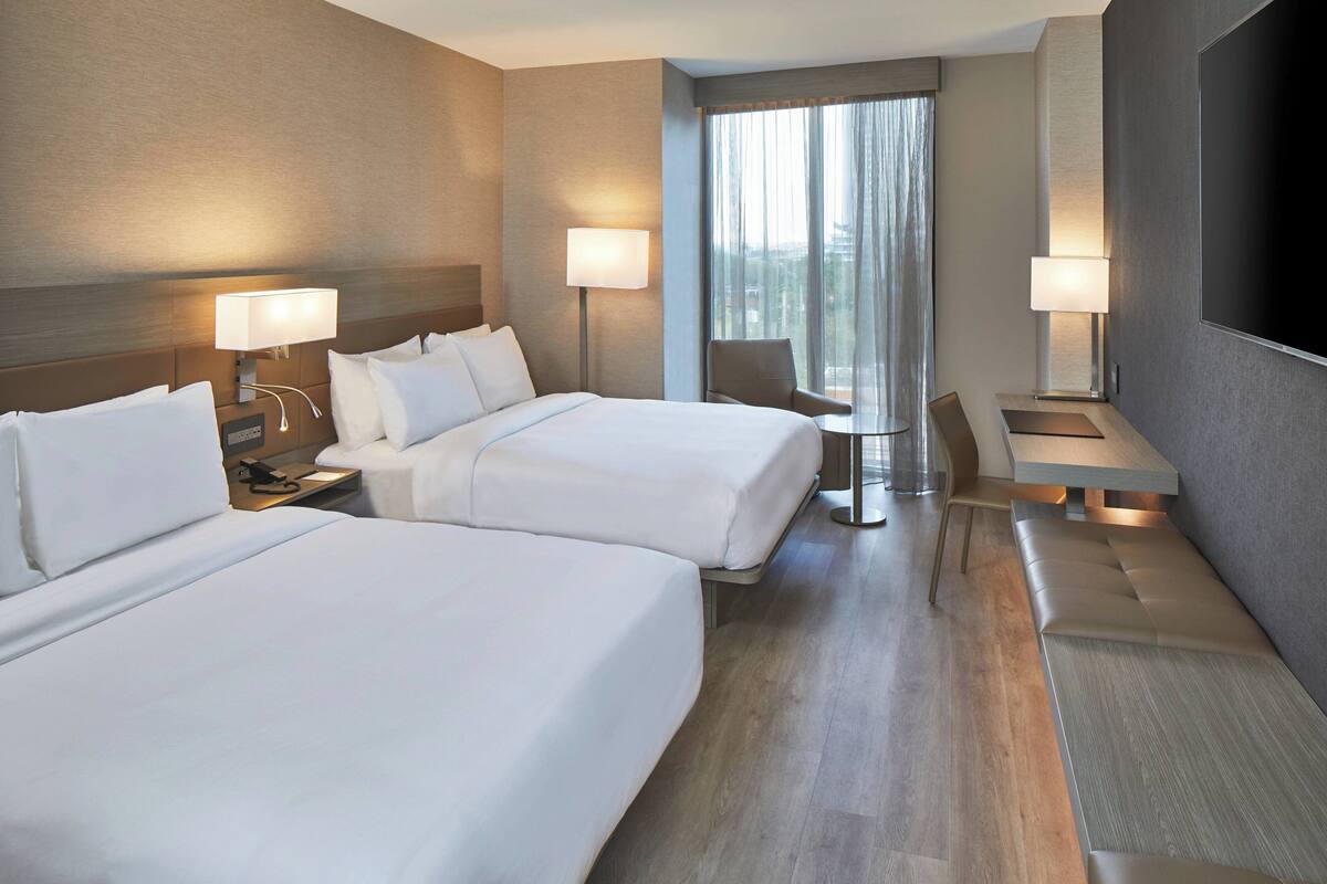 Premium bedding, pillow-top beds, desk, laptop workspace