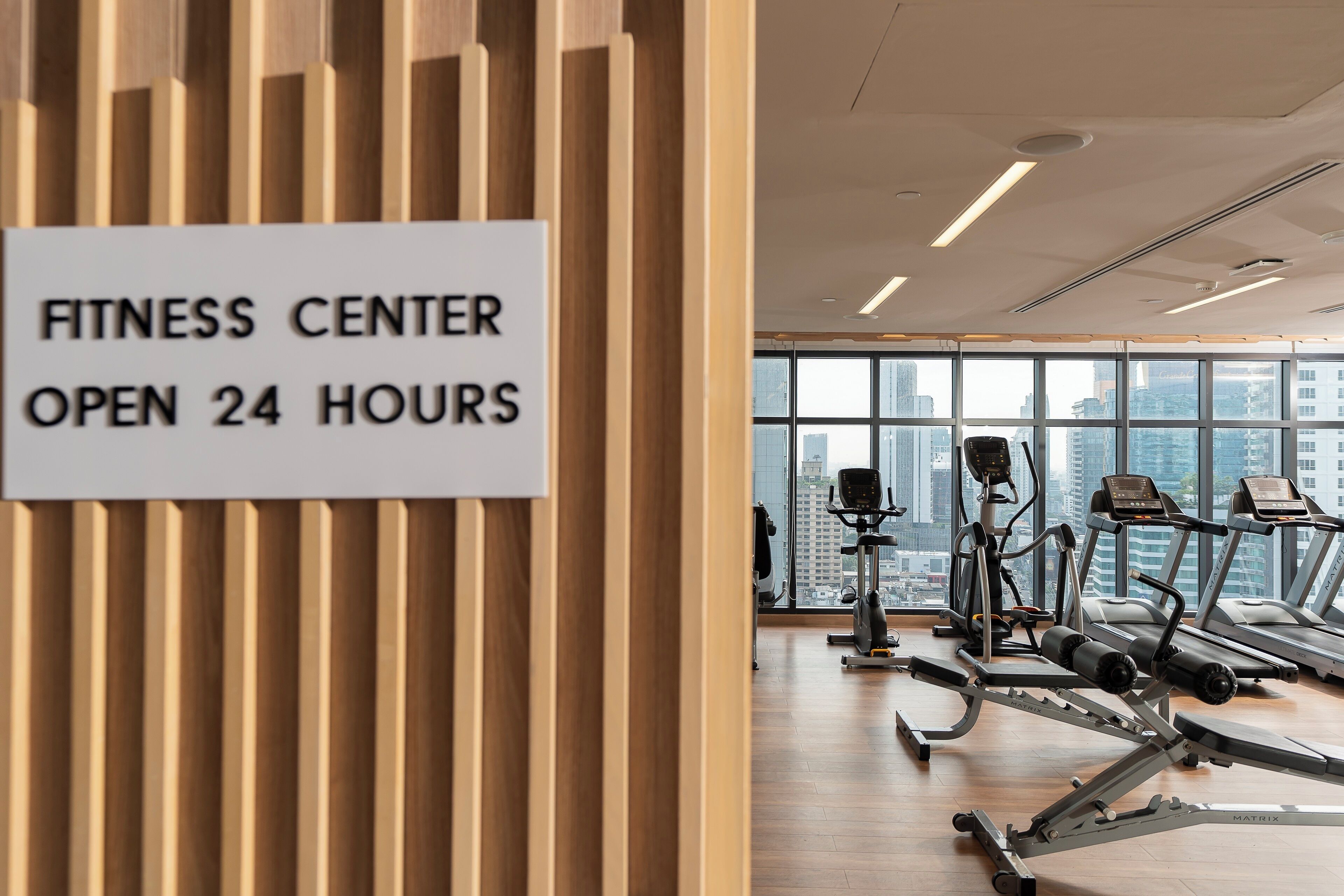 A fitness center with a sign indicating it is open 24 hours.