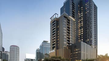 A high-rise hotel with multiple floors, large windows, and a prominent sign.