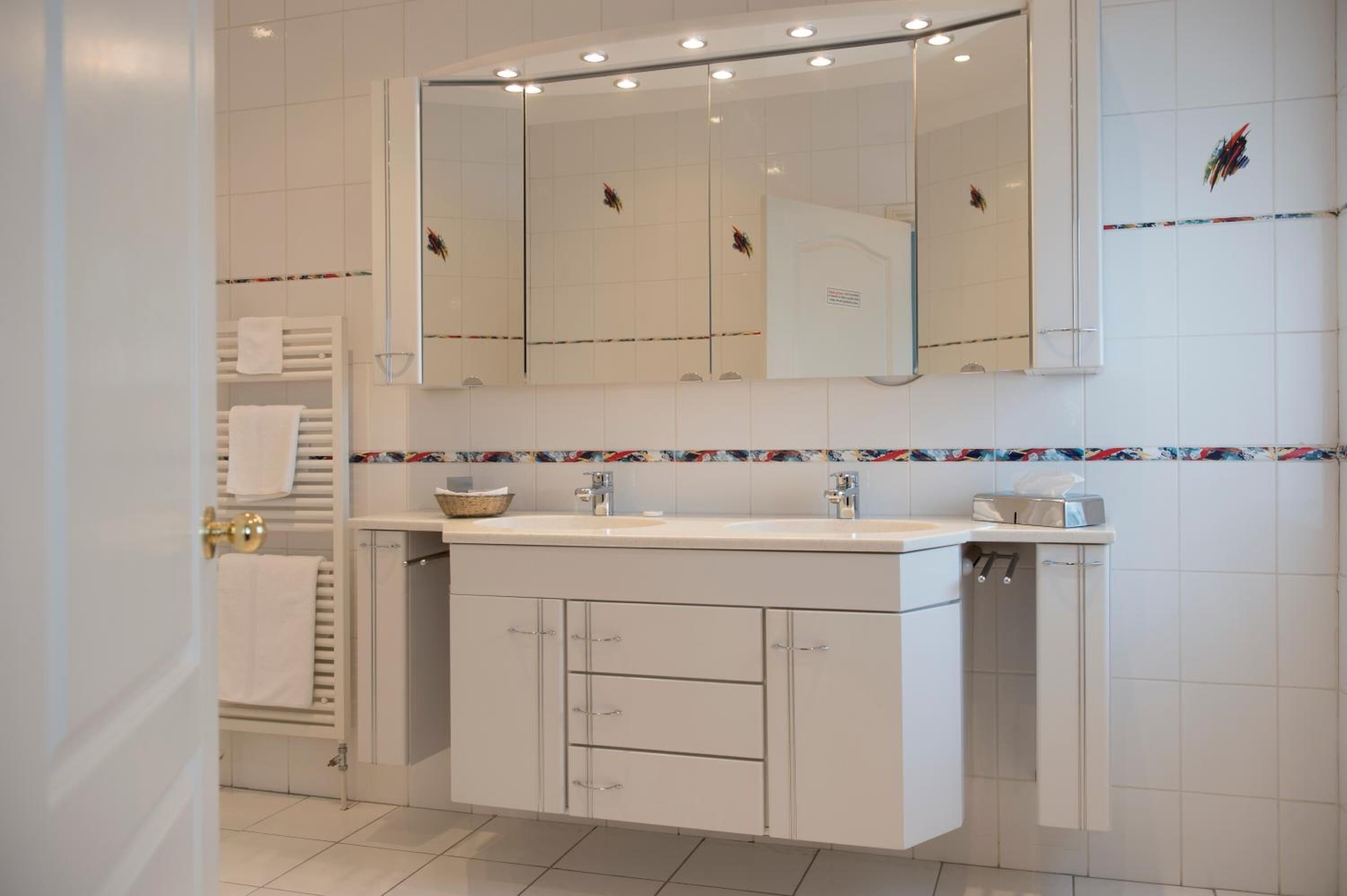 designer toiletries, hair dryer, towels, soap