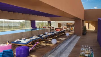 Relax by the pool with a drink in hand, surrounded by comfortable loungers and a stunning view.
