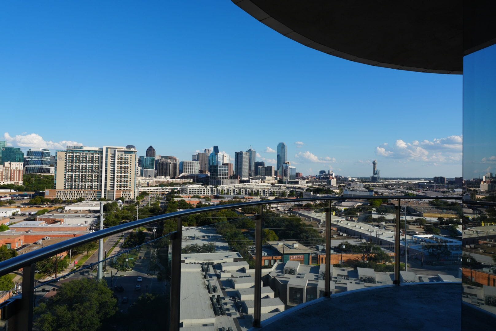 A city skyline with modern buildings, a bridge, and a clear sky.