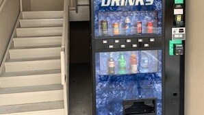 A vending machine labeled "COLD DRINKS" with various beverage options. - Lotus inn (Houston)