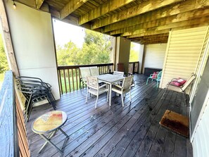Enjoy al fresco dining on the deck, surrounded by lush greenery.