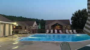 A swimming pool with lounge chairs and a covered patio area. - Beautiful Branson Getaway! (Branson)