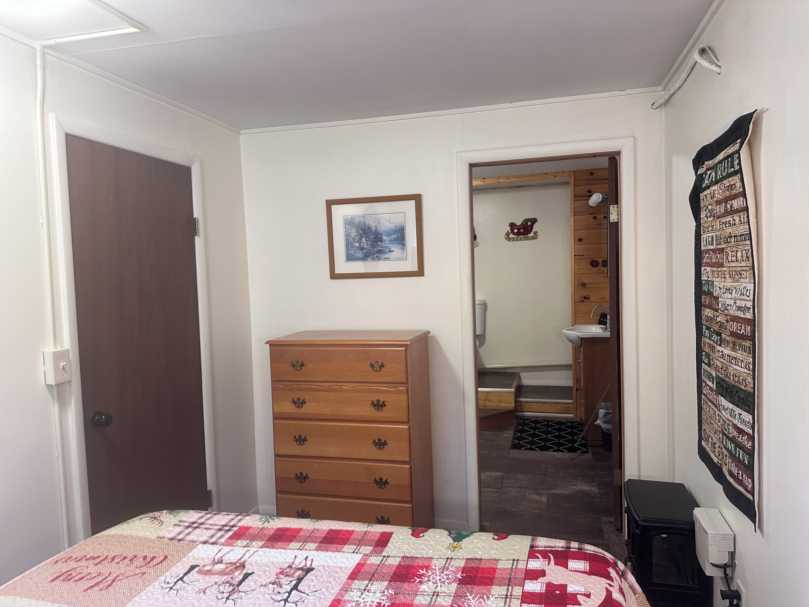 Bedroom with dresser and private entrance to bathroom