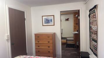 Bedroom with dresser and private entrance to bathroom