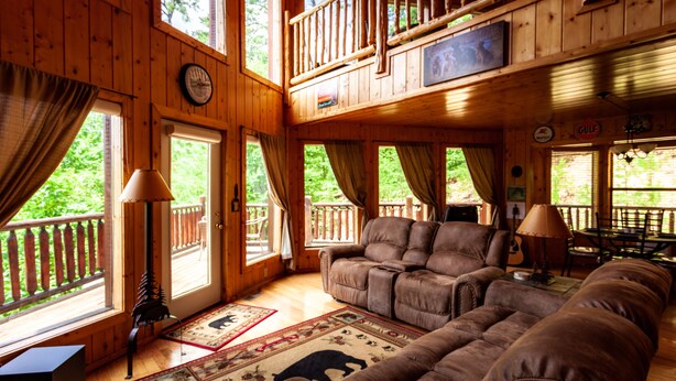 A spacious cabin with a large living area, a balcony, and a dining area. - 2BR 2BTH PRIVATE, HOT TUB POOL TABLE (Sevierville)