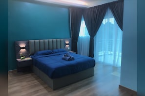 Relax in this serene bedroom with a large bed, grey headboard, and two bedside tables.