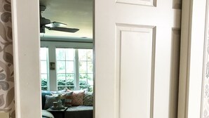 A bedroom with a bed, a window, and a ceiling fan. - Walk to Death Valley! | Cozy Lakeside Suite (Clemson)