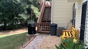 A patio with a grill, outdoor seating, and a small garden area. - COZY Private APARTMENT "3Bedroom/1Bathroom" (Conyers)
