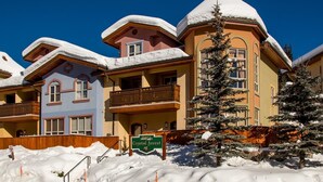 A hotel with multiple buildings, each with balconies and snow-covered roofs.