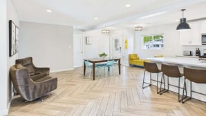 A modern interior with a dining area, kitchen, and bar seating.