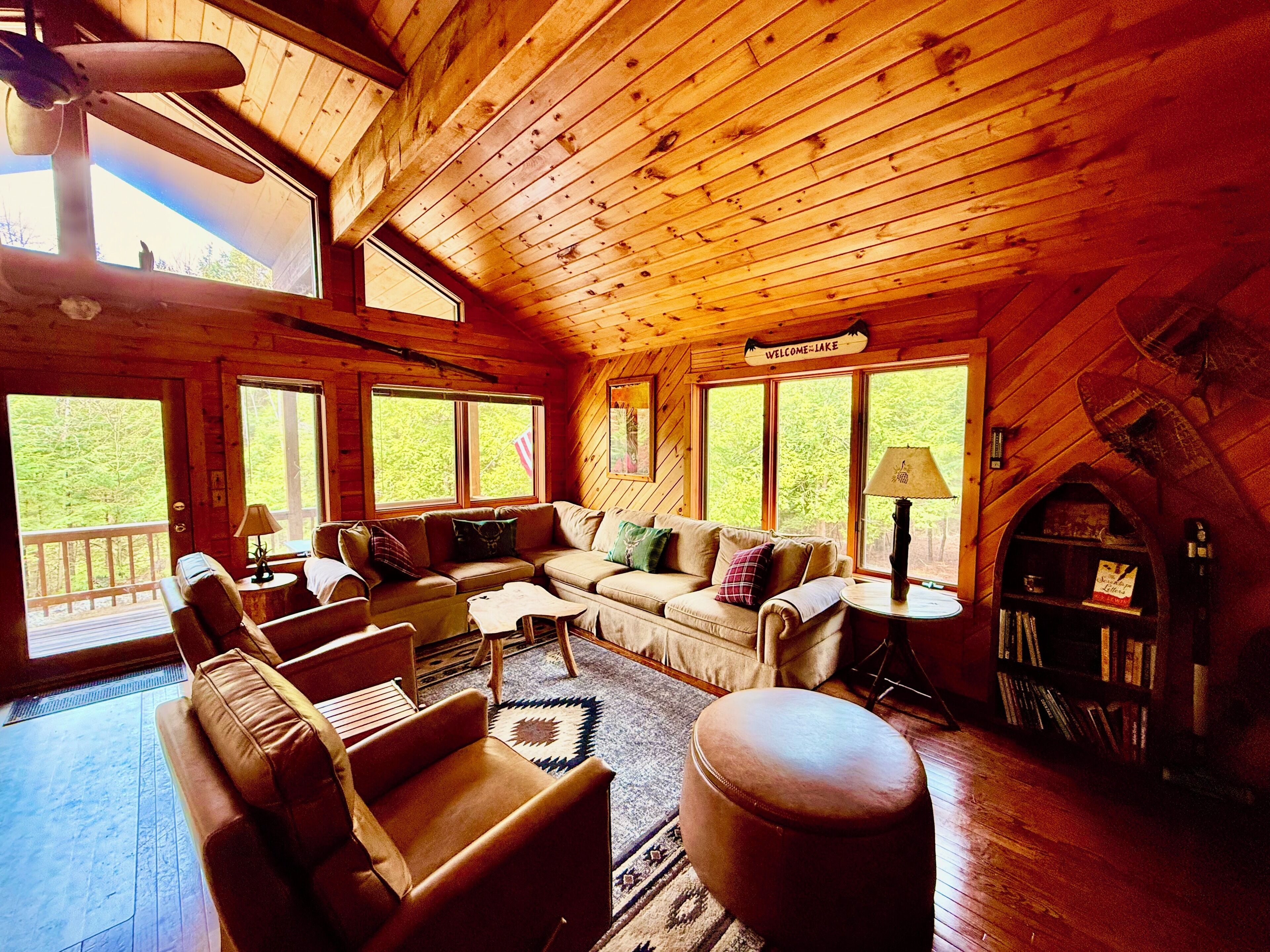 2nd floor great room living space with plenty of seating and gigantic smart tv.