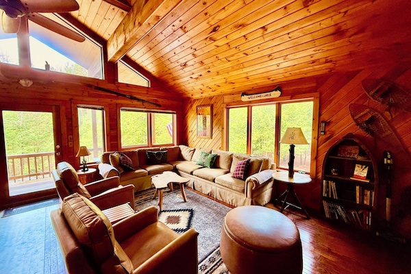 2nd floor great room living space with plenty of seating and gigantic smart tv.