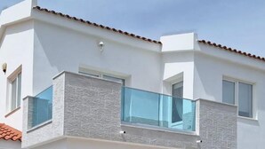 A modern two-story house with a covered patio area, a balcony, and a hammock. - 2 bedroom detached villa with private pool in Ayia Thekla (Ayai thekla)