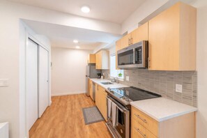 Fridge, microwave, coffee/tea maker, cookware/dishes/utensils