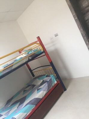 Cozy sleeping quarters feature a bunk bed with a wooden frame and a headboard.