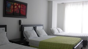 A hotel room with two beds, a painting on the wall, a phone on the nightstand, and a window with curtains. - Hotel Aussie Koala (Armenia)