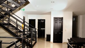 A hotel lobby with a staircase, a reception desk, and a door leading to a room. - Hotel Aussie Koala (Armenia)