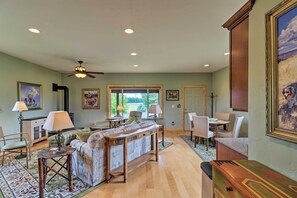 Relax in this spacious living area with a high ceiling, large window, and comfortable seating.