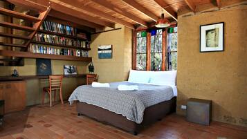 Relax in this charming bedroom with a comfortable bed, wooden desk, and bookshelf.