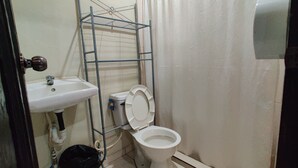 A bathroom with a white sink, toilet, and shower curtain. - Bosques del Tibet (Santa Ana)