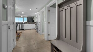 A modern kitchen with white cabinetry, a built-in oven, and a stainless steel refrigerator. - Treasure Island 0805 (Panama City Beach)