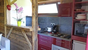 A rustic kitchen with wooden beams, a window, a coffee maker, and a dishwasher. - Beautiful apartment for 4 guests with WIFI, TV and balcony (Saint-gervais-les-bains)