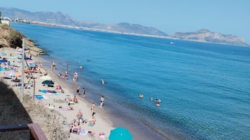 On the beach, sun-loungers