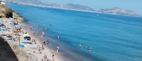 On the beach, sun-loungers