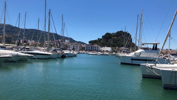 A marina with multiple boats docked, calm water, and a mountainous backdrop. - Secluded, Spacious, Luxury Villa & Swimming Pool in Beautiful Rustic Location  (Benidoleig)
