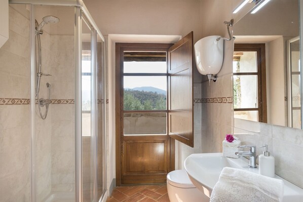 Un baño con ducha, inodoro y lavabo.